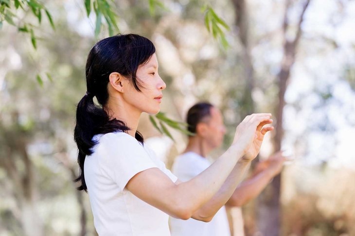 People practicing thai chi in park